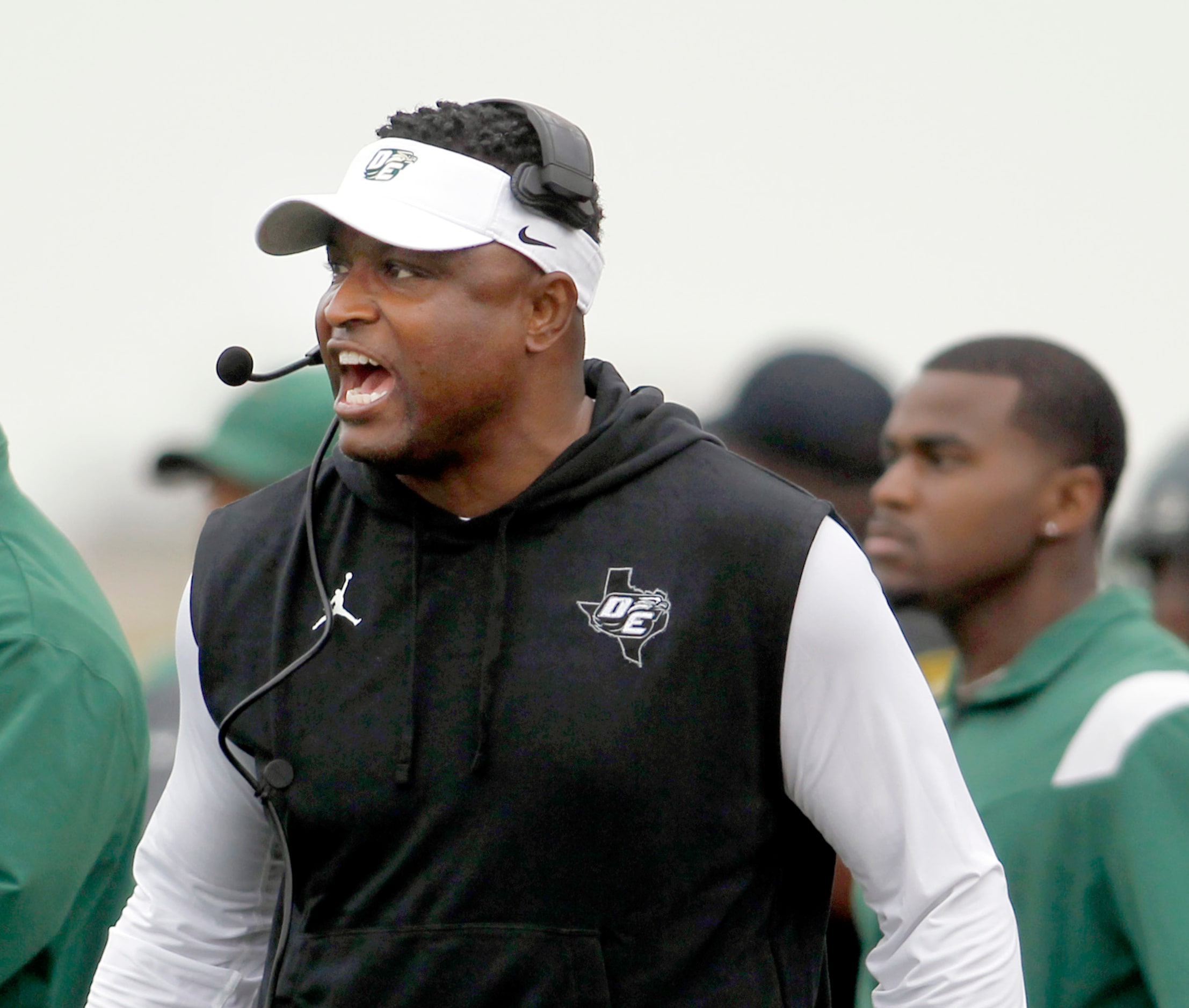 DeSoto head coach Claude Mathis directs his players from the team bench area during first...