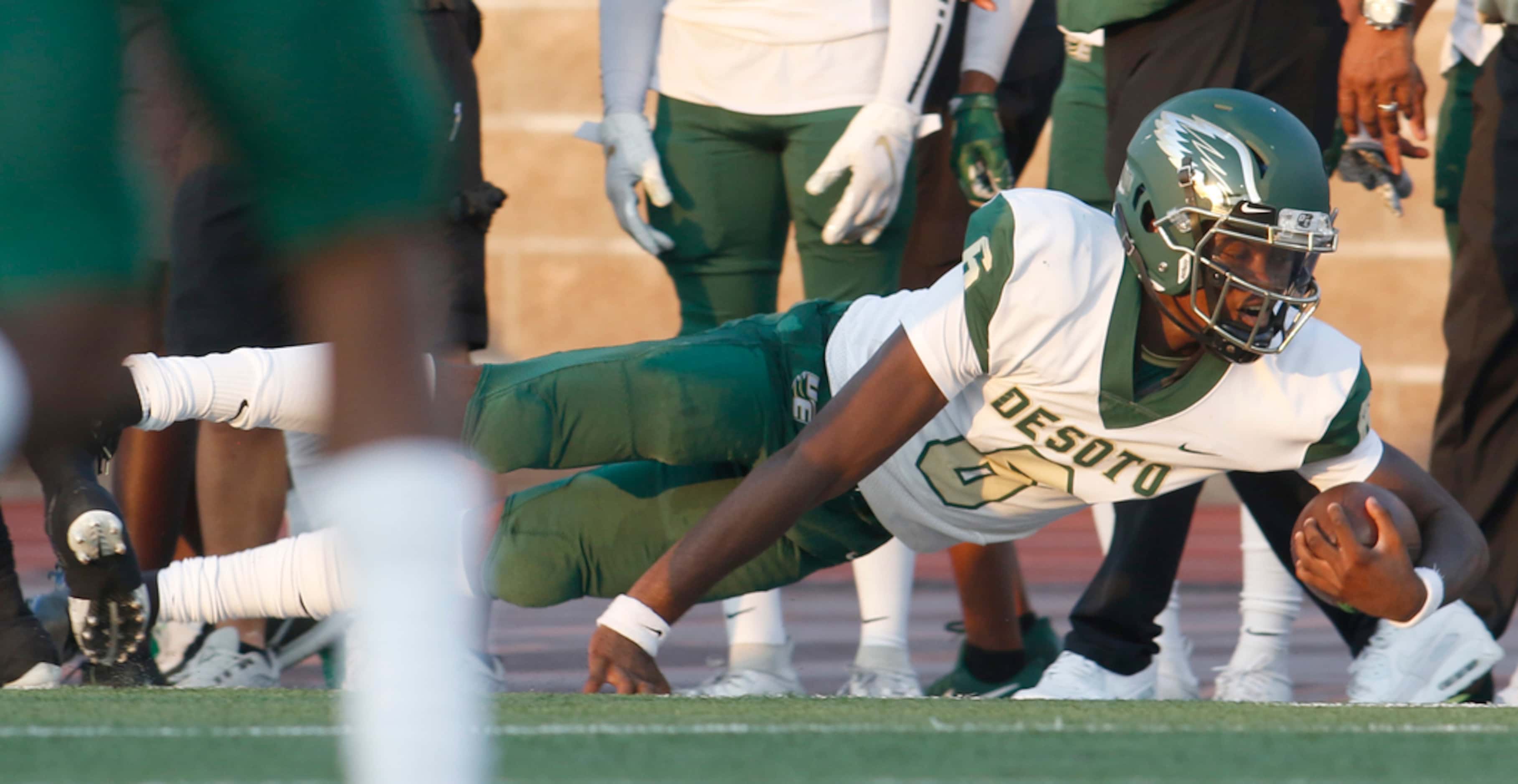 DeSoto quarterback Samari Collier (6) lunges for extra yardage after being tripped up by a...