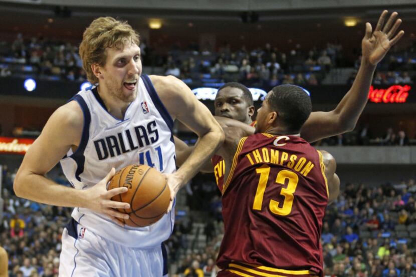 Dallas' Dirk Nowitzki (41) drives past Cleveland's Tristan Thompson (13) in the second...