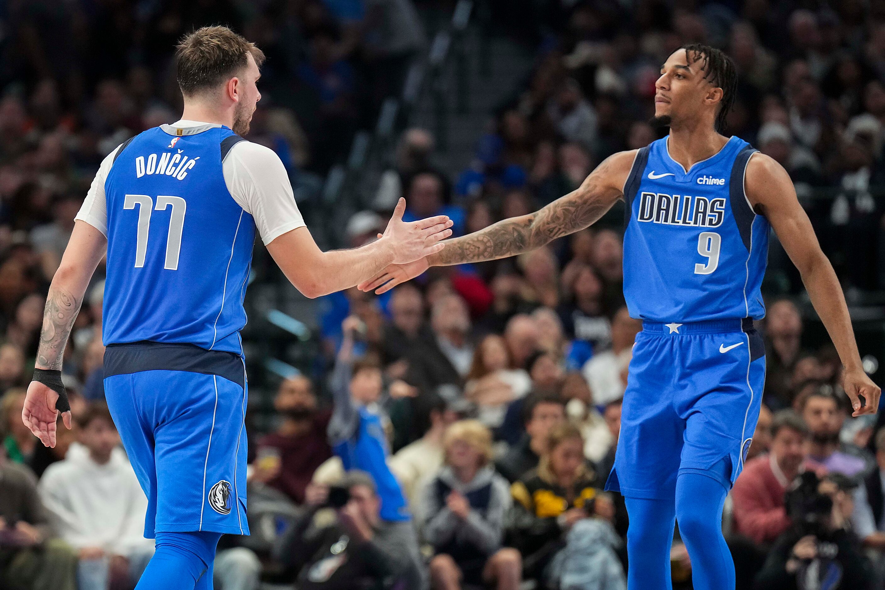 Dallas Mavericks guard Luka Doncic (77) celebrates a basket with guard A.J. Lawson (9)...