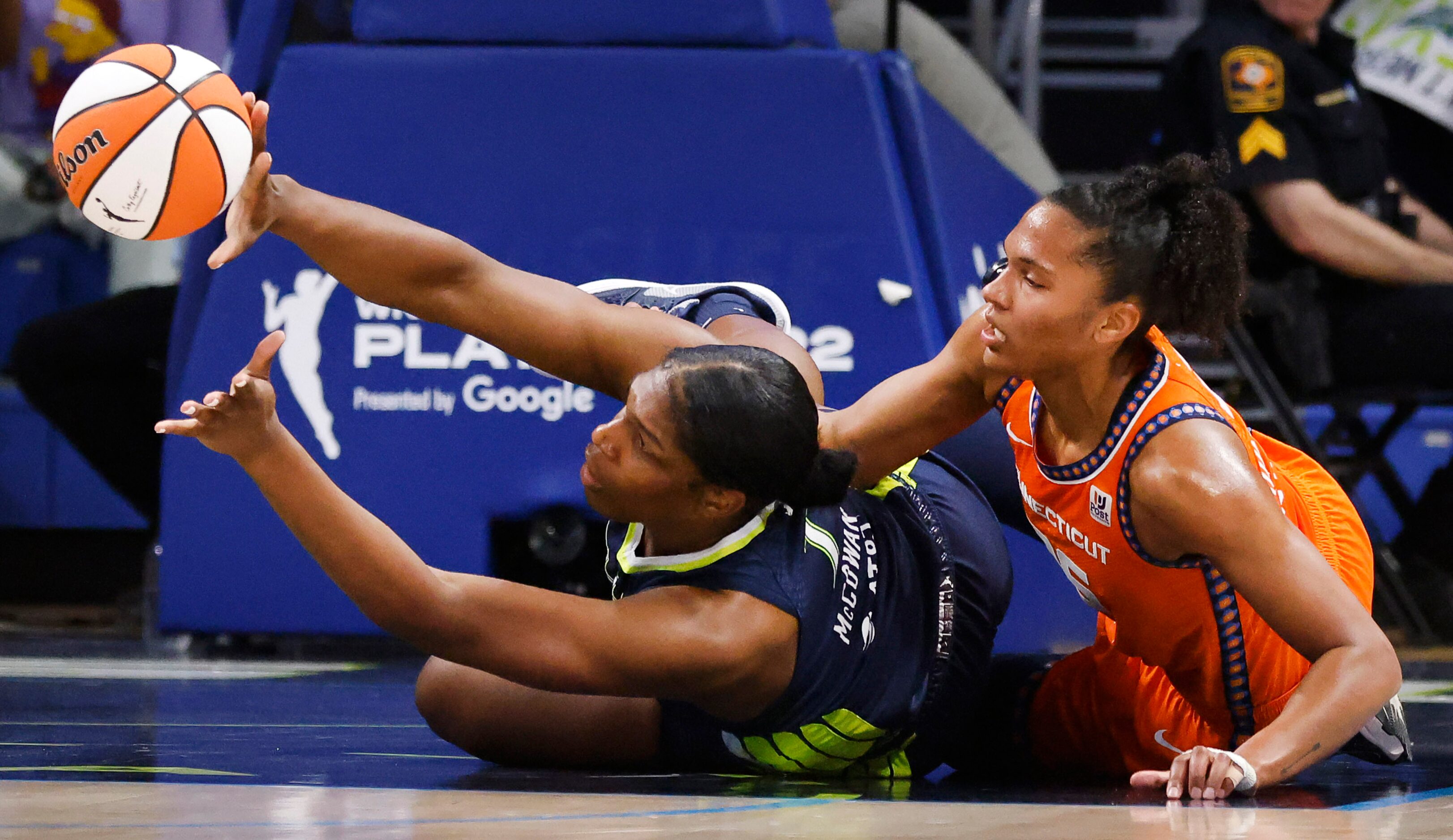 Dallas Wings center Teaira McCowan (7) passes the ball after going to the floor against...