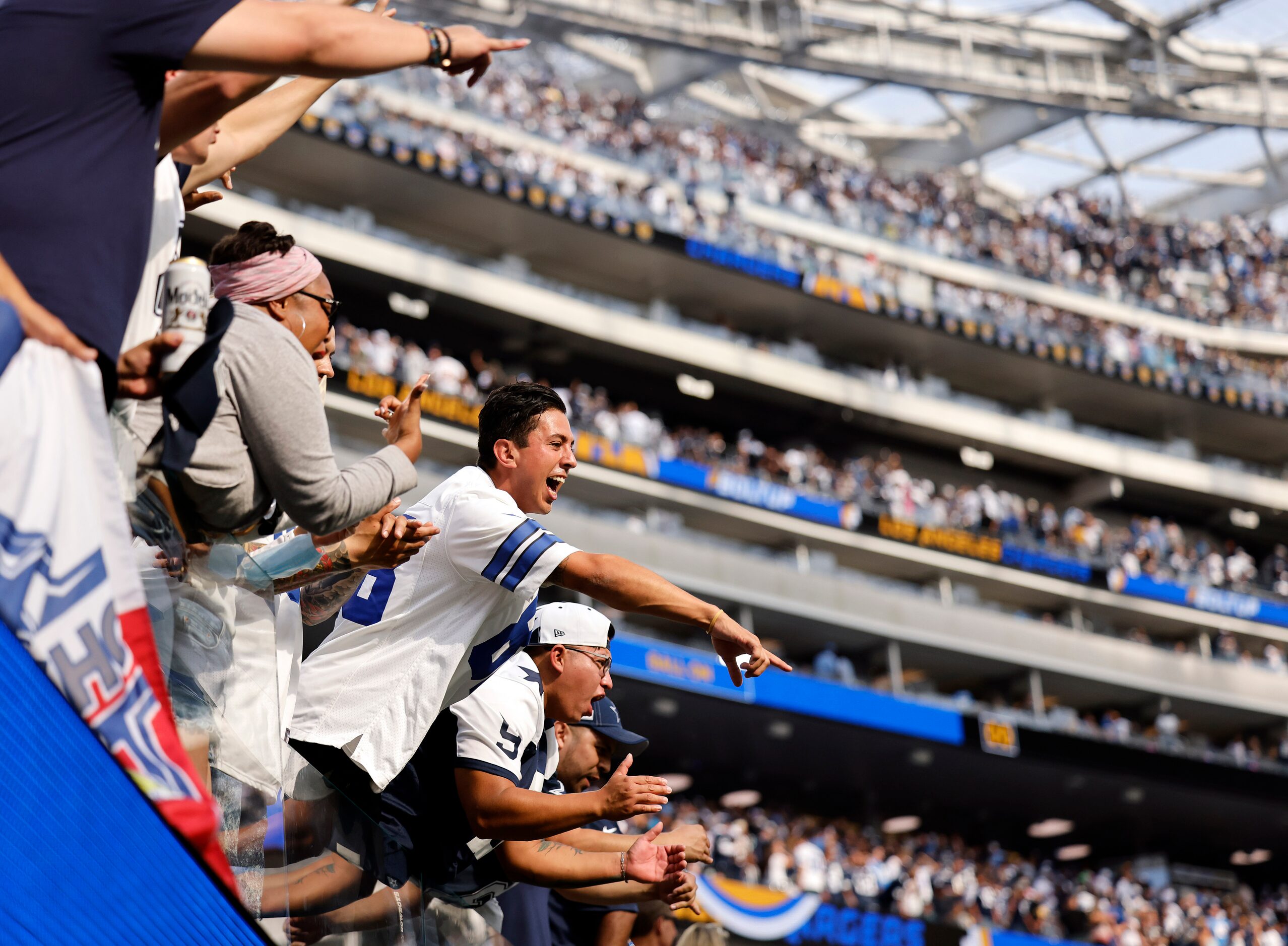 Dallas Cowboys fans go crazy for their players as they walk off the field with a win against...