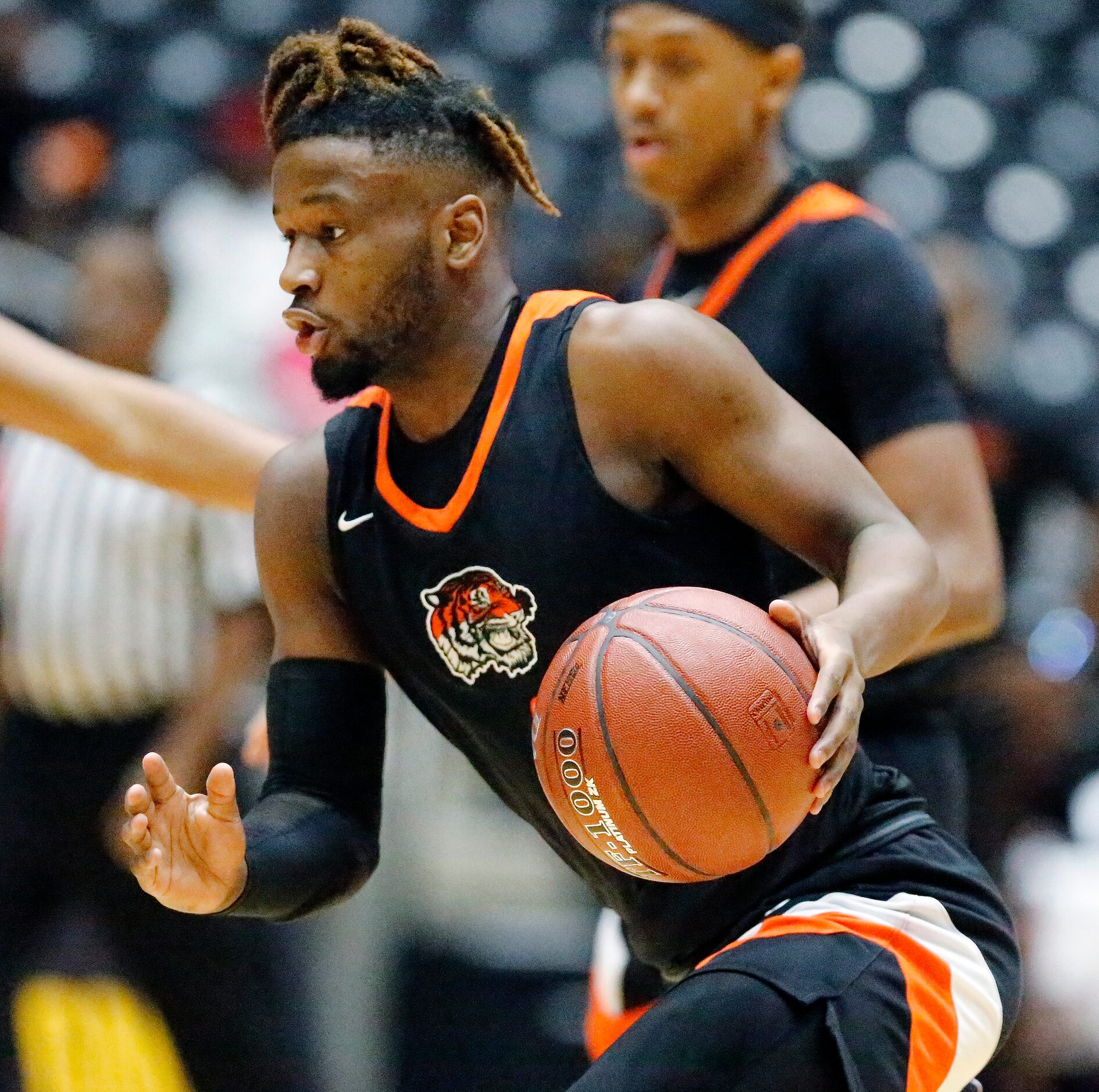 Lancaster High School guard Mike Miles (1) drives toward the basket during the first half as...