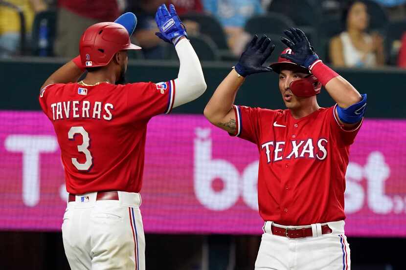 Texas Rangers' Mark Mathias, right, celebrates his home run that also scored teammate Leody...