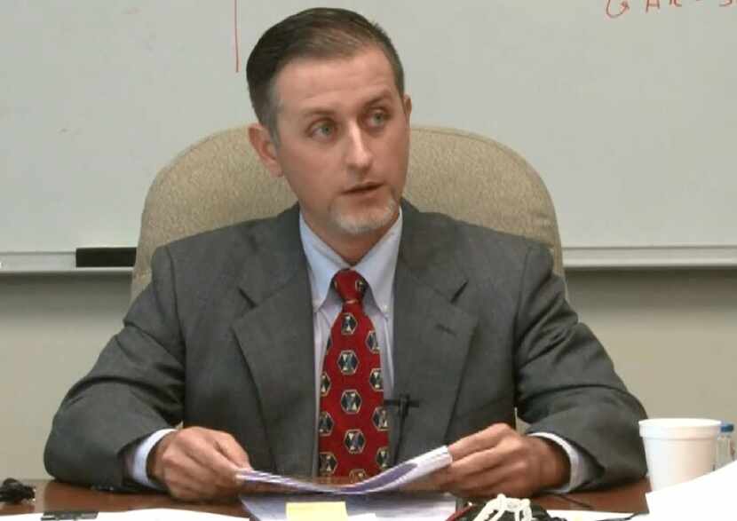 Texas Department of Public Safety forensic scientist Chris Youngkin answers questions during...