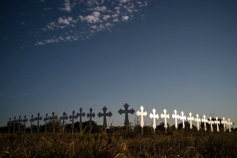 A long row of 26 crosses set up on the edge of Sutherland Springs, Texas, Nov. 6, 2017, one...