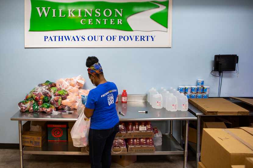 Get Shift Done worker Shkoryah Carthen prepares a bag of food at the Wilkinson Center in...