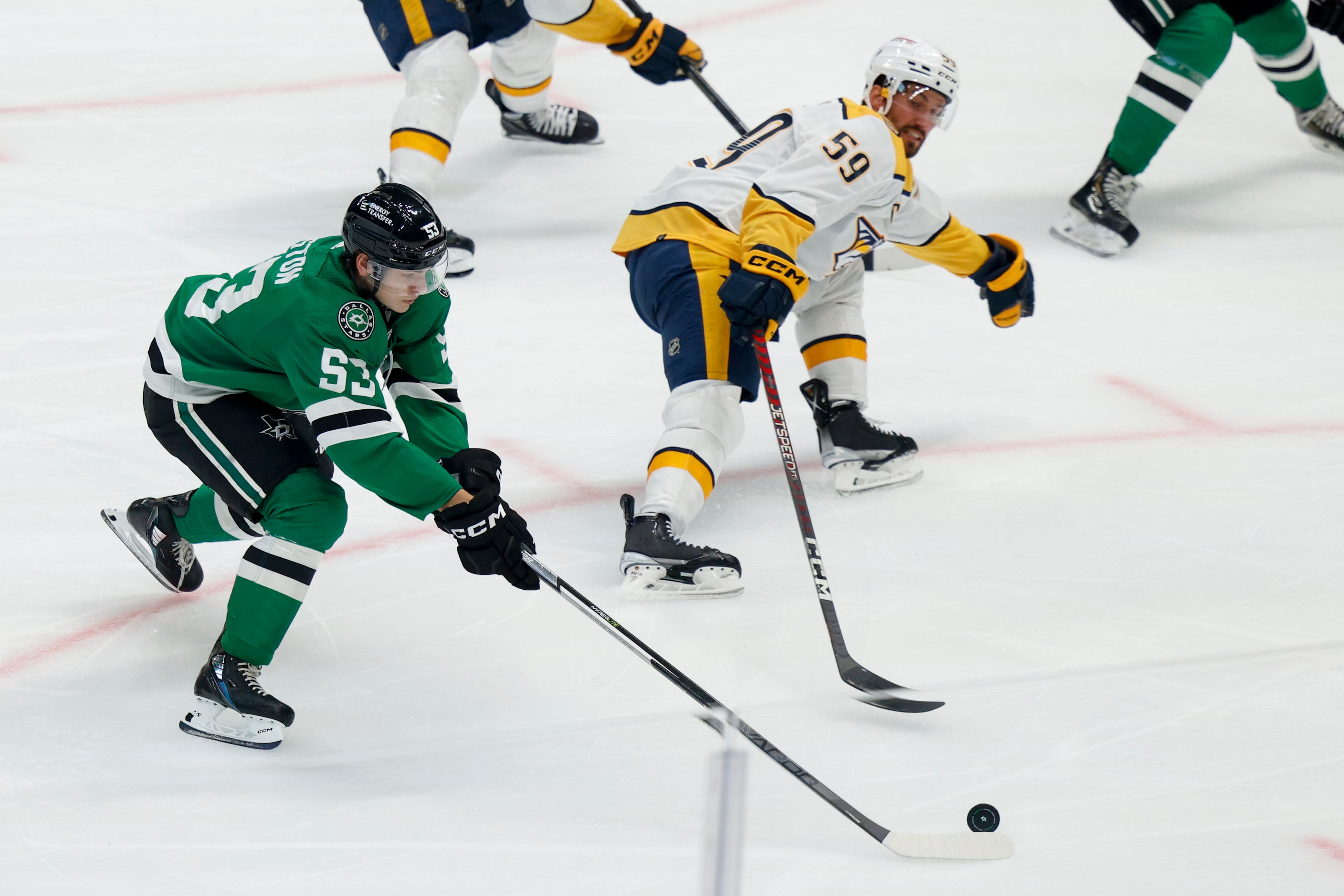 Dallas Stars center Wyatt Johnston (53) passes the puck alongside Nashville Predators...