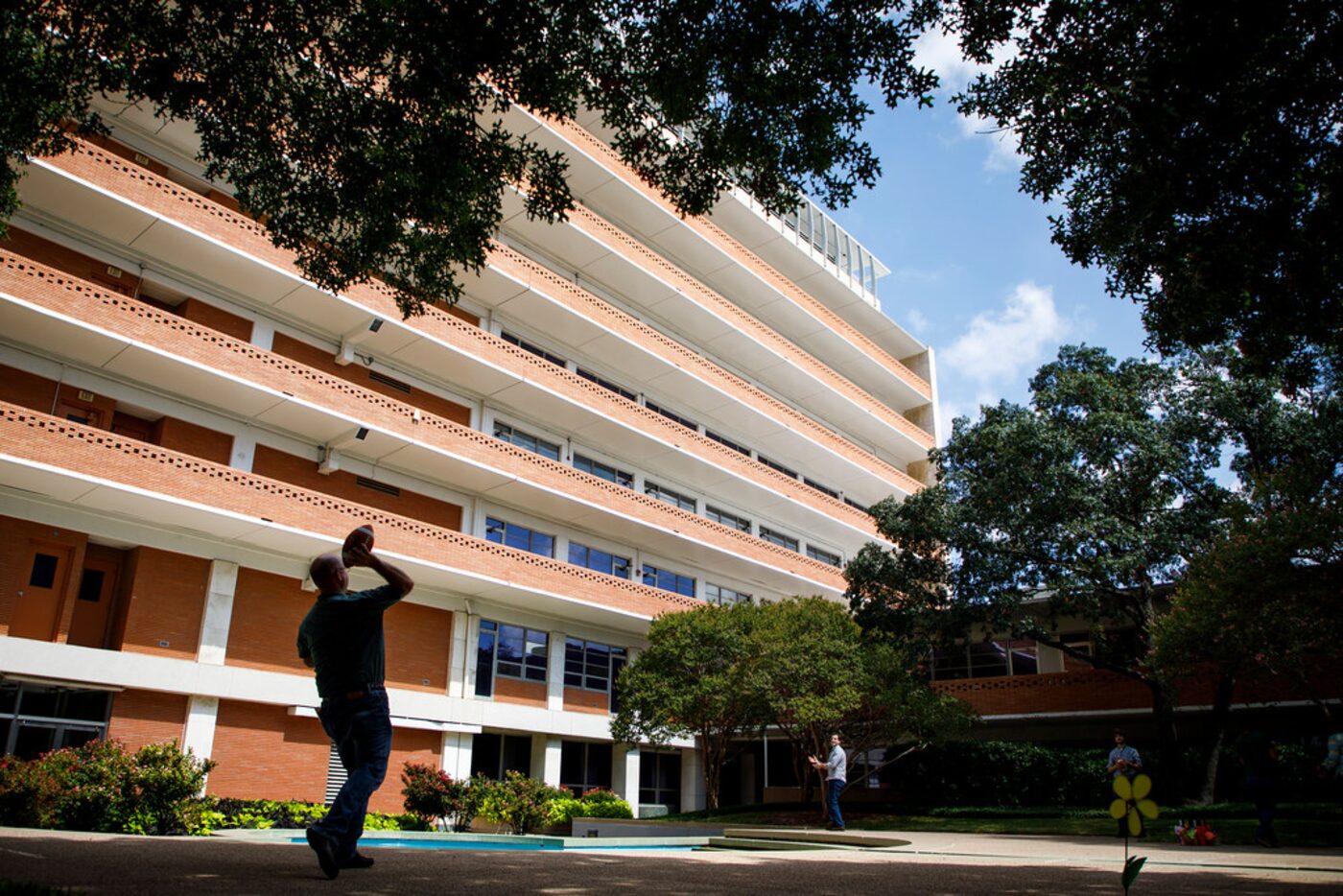 Encompass Home Health & Hospice employees toss a football during the company's Fall Festival...