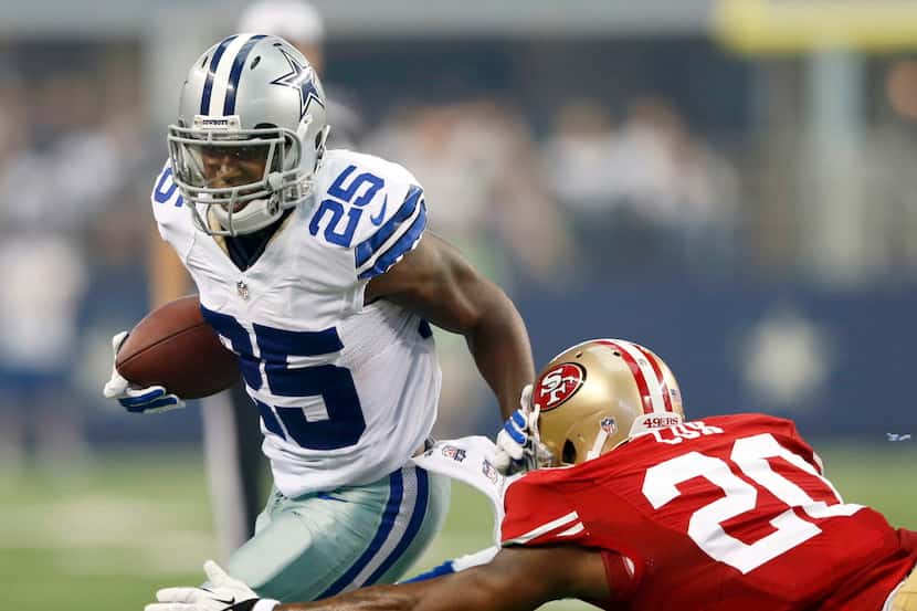 Dallas Cowboys running back Lance Dunbar (25) attempts to get by San Francisco 49ers...