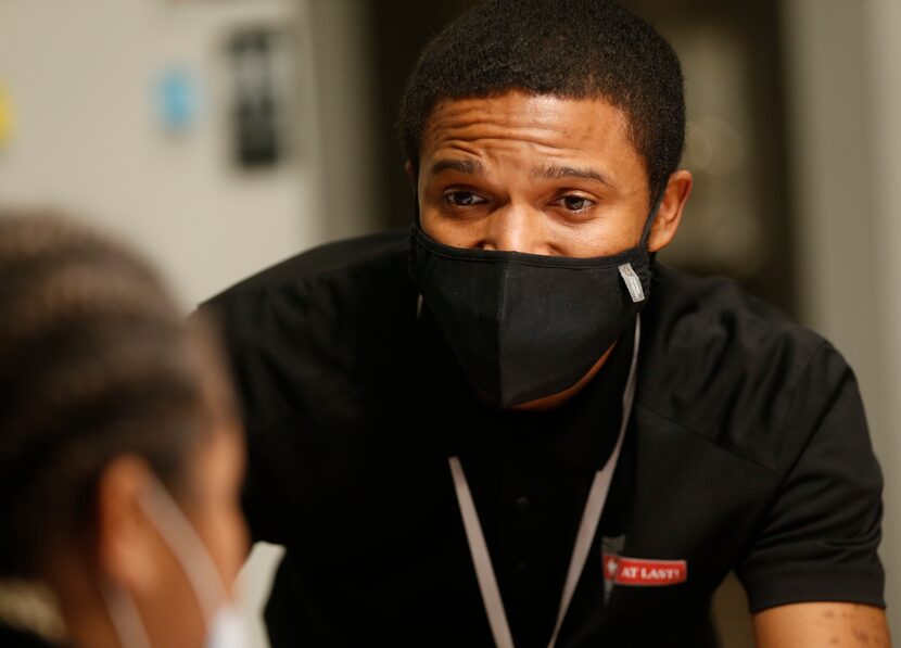 Cornell Lacy works with a scholar during the writing enrichment exercises. “Once a week one...