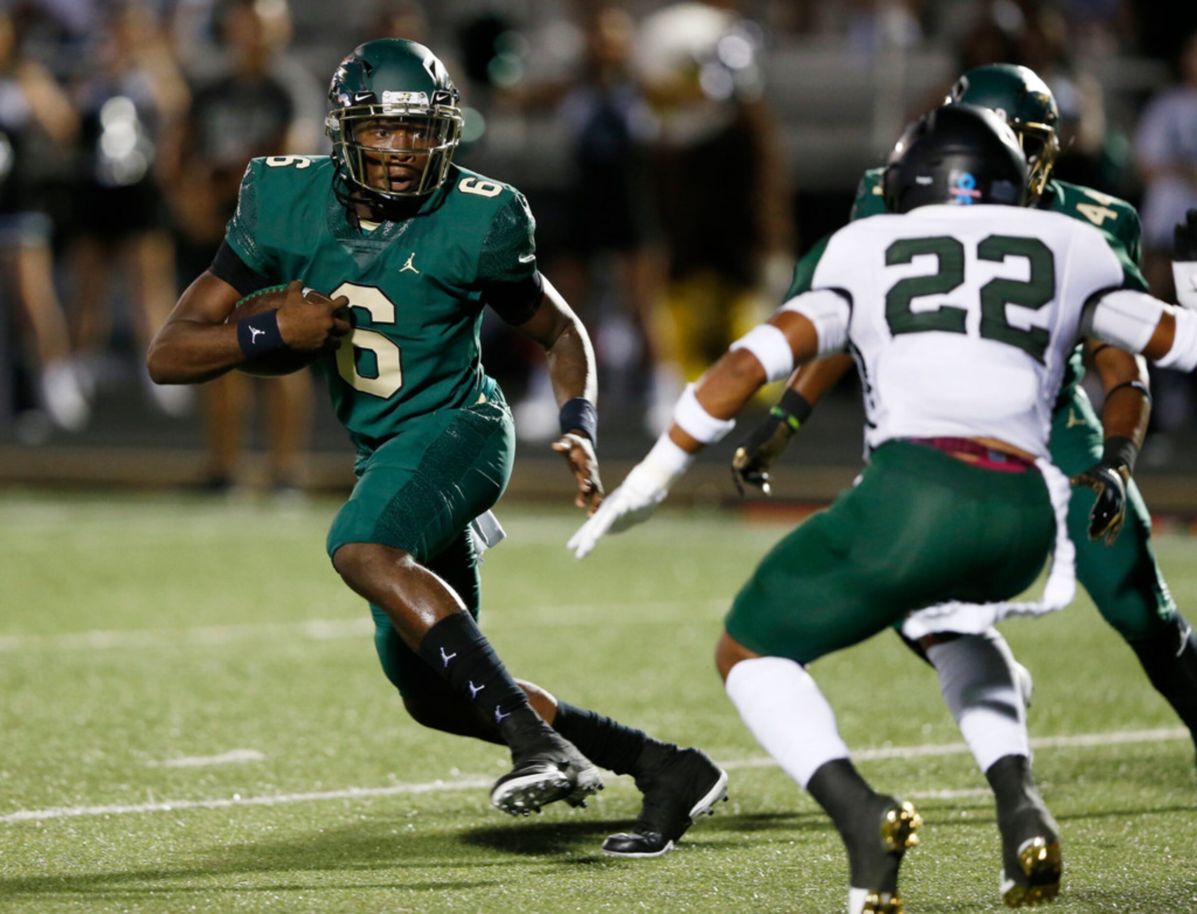 DeSoto's Samari Collier (6) looks to run as Mansfield Lake Ridge's Datrell Mitchel (22)...