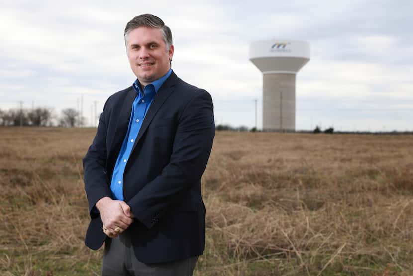 Jason Moore, executive director of Mansfield Economic Development Corp., stands in the field...