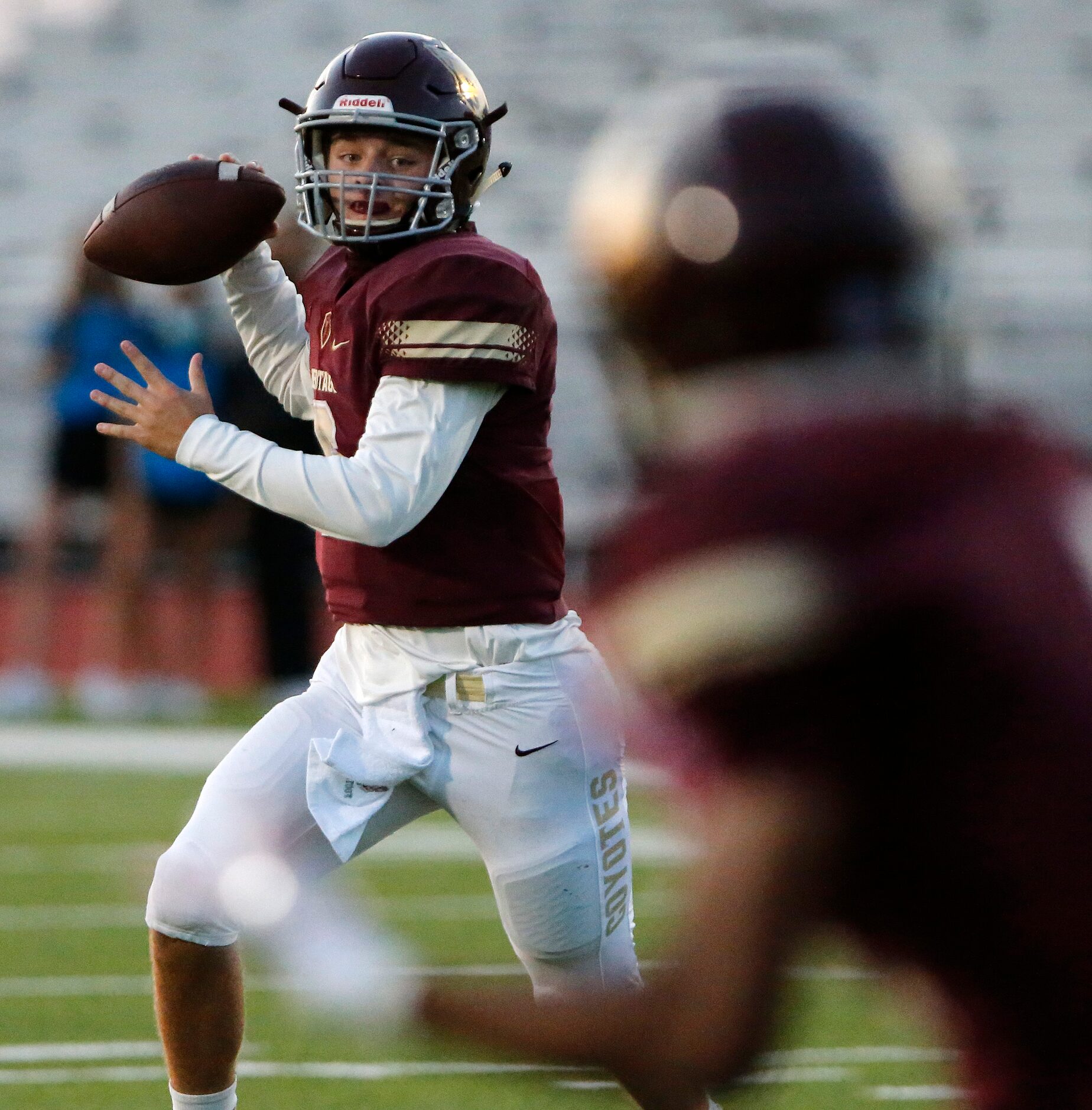 Heritage High School quarterback Easton Swetnam (6) rolls out before throwing a touchdown...