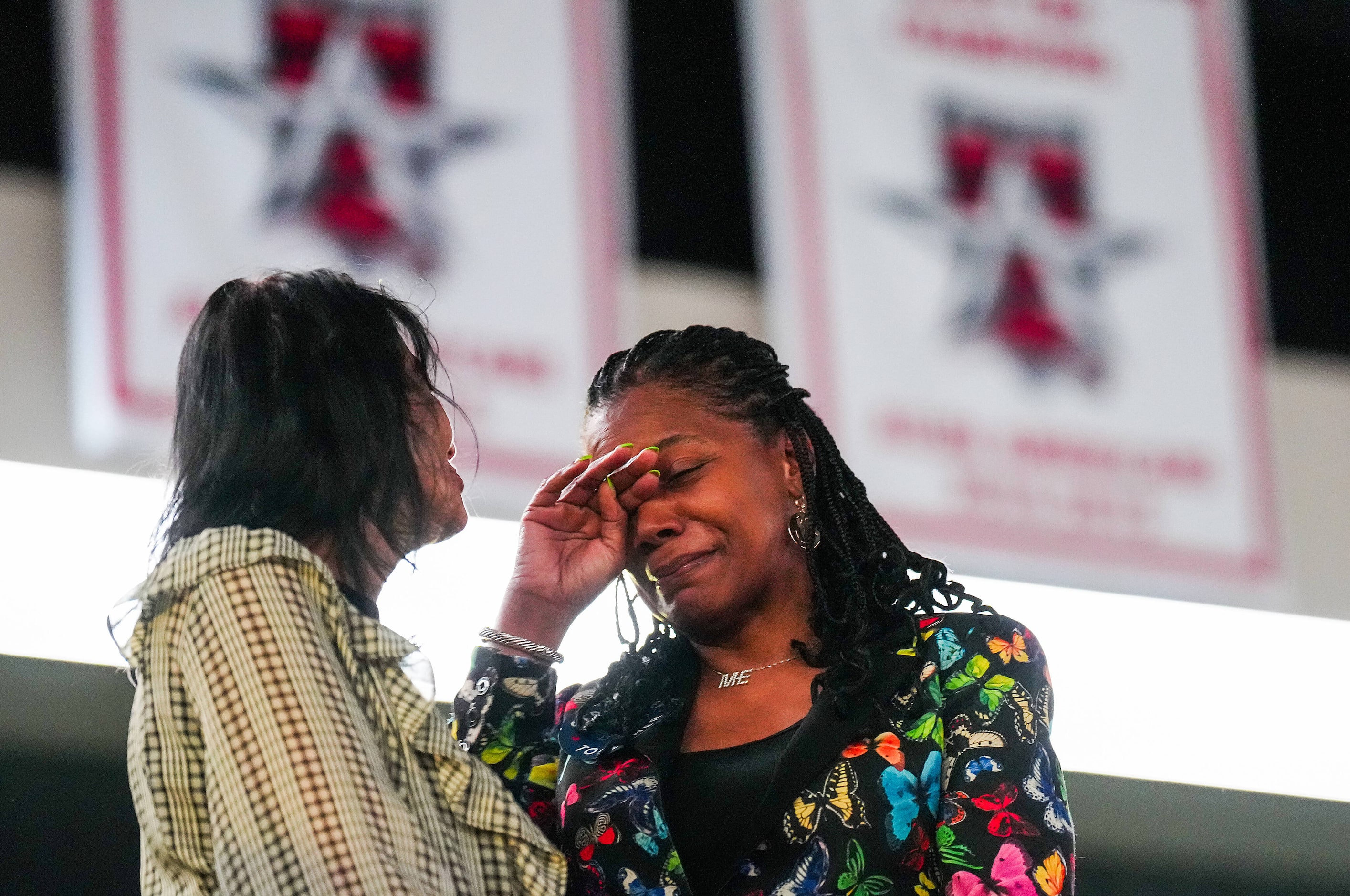 Cheryl Jackson (right) wipes away tears as she talks with Nina Majmundar as they arrive for...