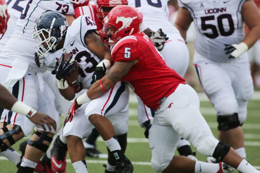 SMU's Randall Joyner (5) tackles Connecticut's tackles Lyle McCombs (43) in the first half...