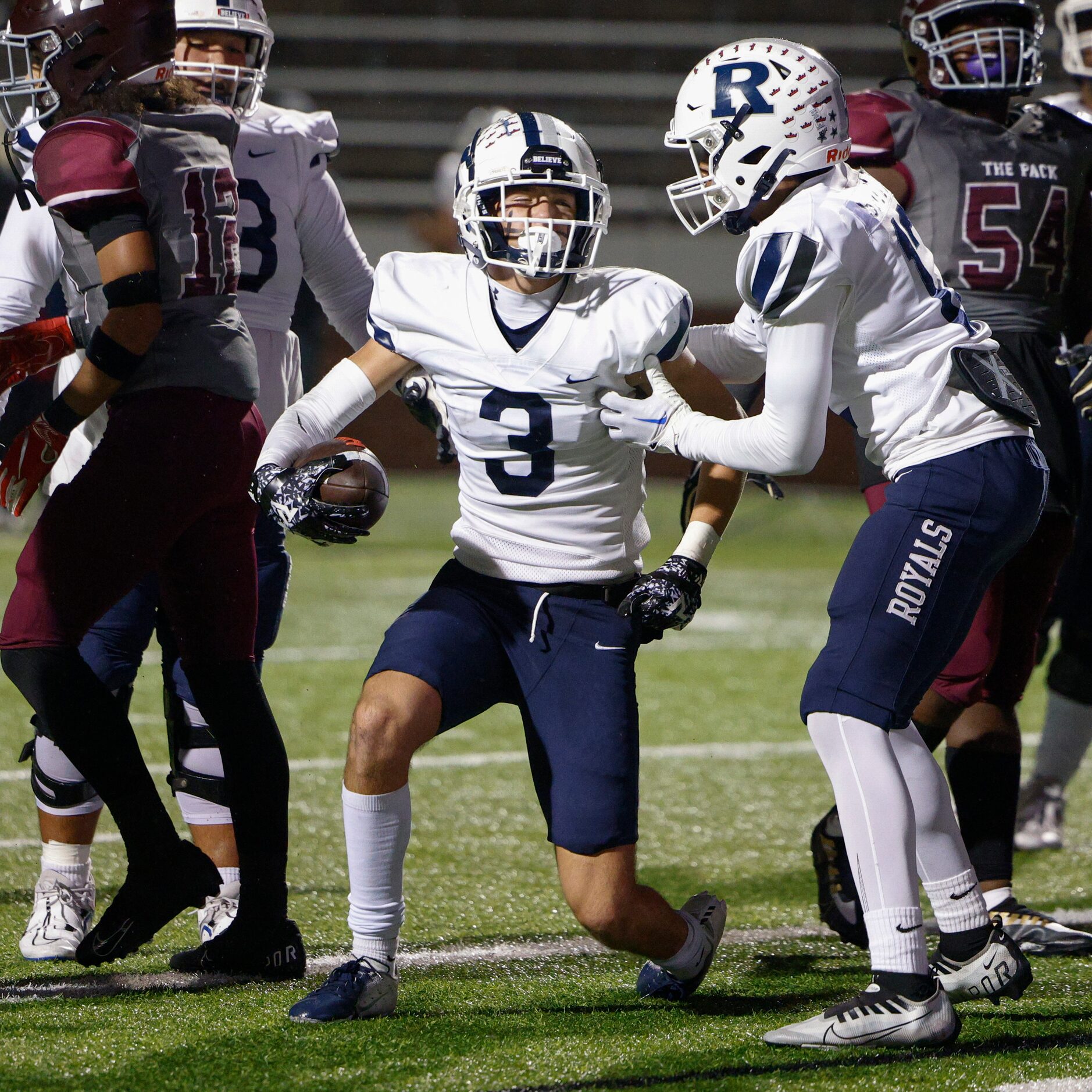 Richland wide receiver Grant Peretz (3) celebrates with wide receiver Evan Smith (12) after...