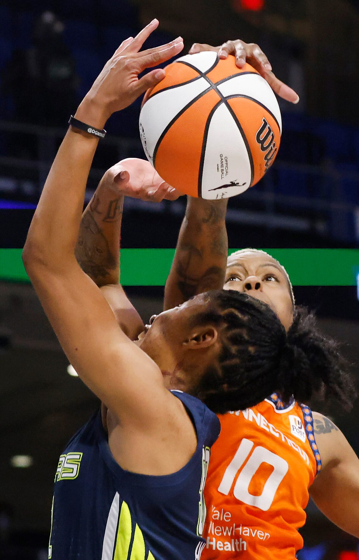 Connecticut Sun guard Courtney Williams (10) blocks a driving shot by Dallas Wings guard...