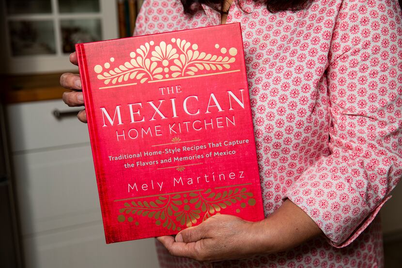 Local author Mely Martínez holds her recently released cookbook, "The Mexican Home Kitchen:...