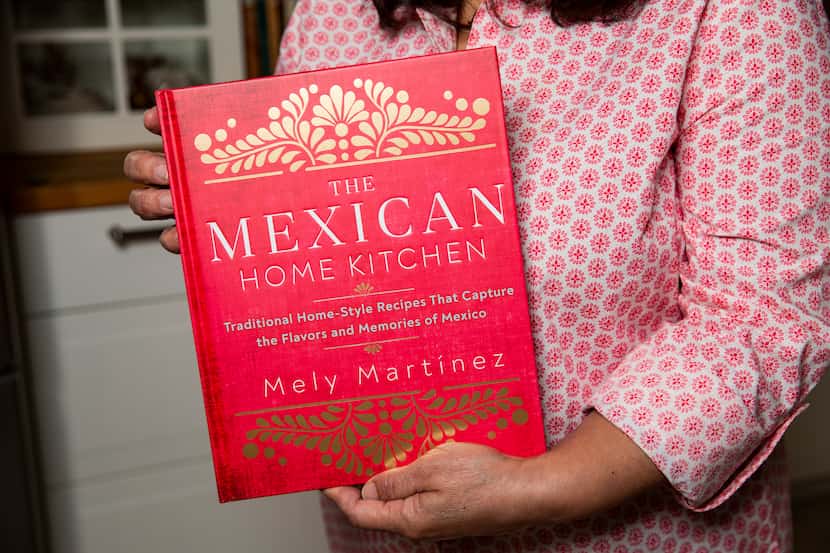 Local author Mely Martínez holds her recently released cookbook, "The Mexican Home Kitchen:...