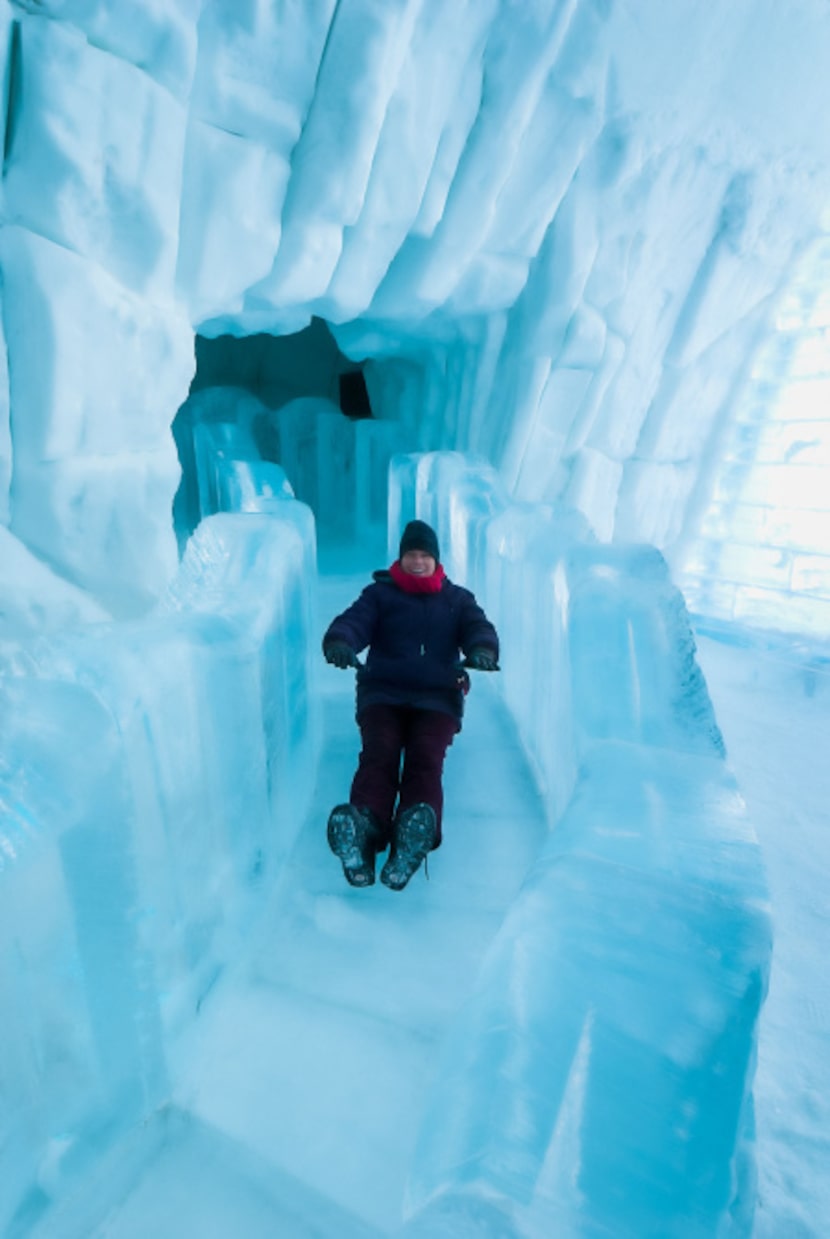 A guest slides down the Grand Slide at Hôtel de Glace.  A quick trip down this circular...