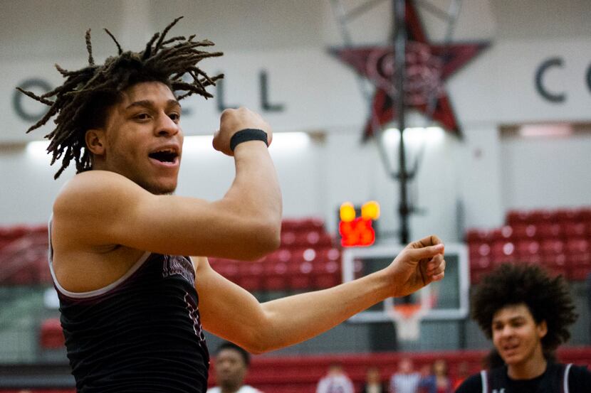 Mansfield Timberview's Joey Madimba celebrates after a dunk during a Class 5A area-round...