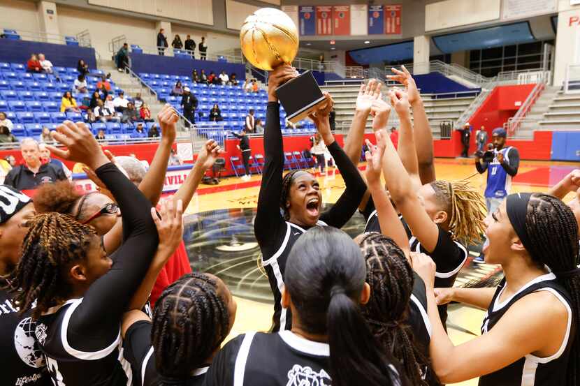 Duncanville's Mariah Clayton (center) and her teammates celebrate following their 62-22...