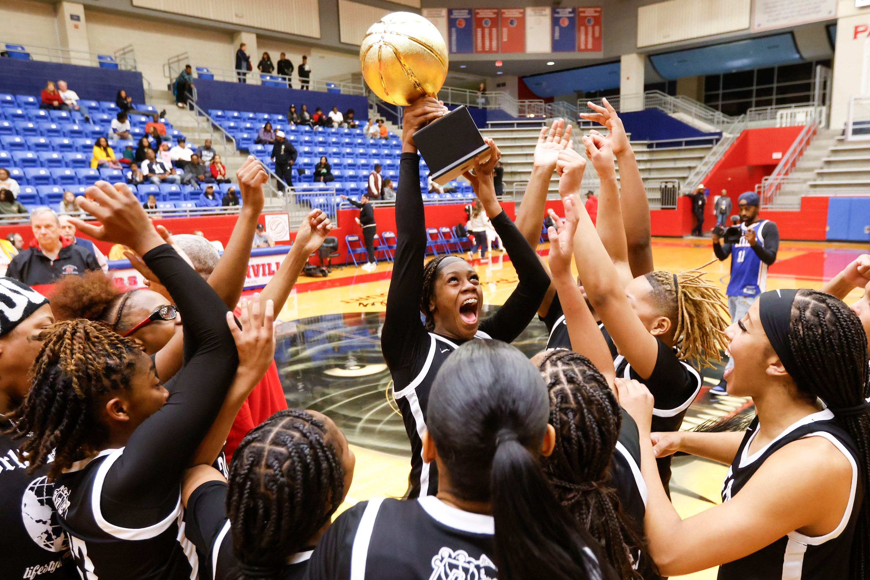 Duncanville high’s Mariah Clayton (center) and her teammates celebrates following their...