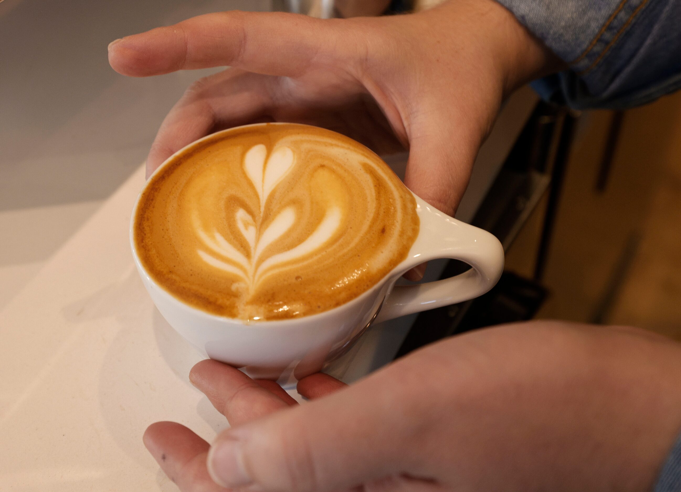 Dorothy Bartke, assistant cafe manager, makes a cappuccino during a soft opening of a new...