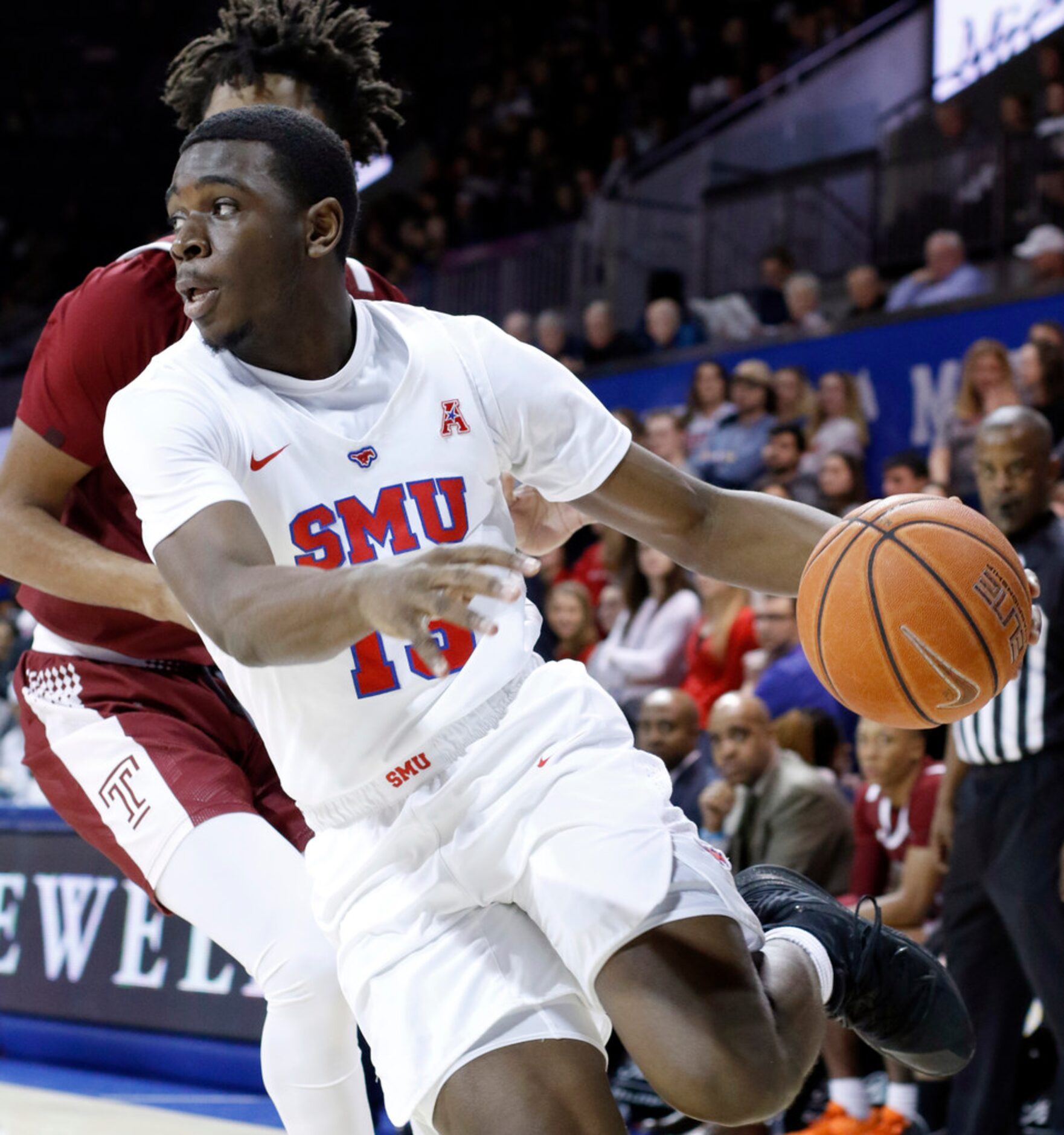 SMU guard CJ White (13) drives the baseline past a Temple defender during first half action....