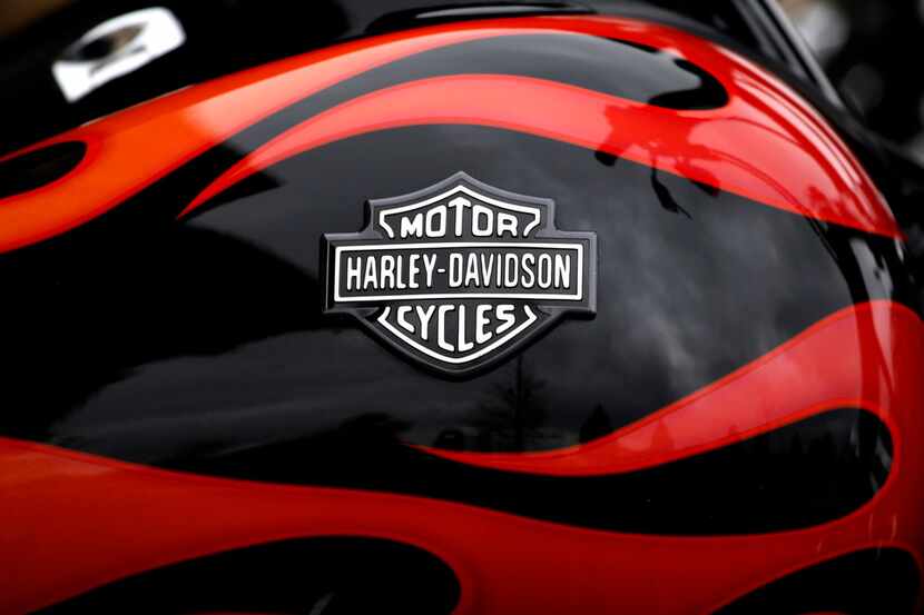 FILE- This April 27, 2017, file photo shows the Harley-Davidson name on the gas tank of a...