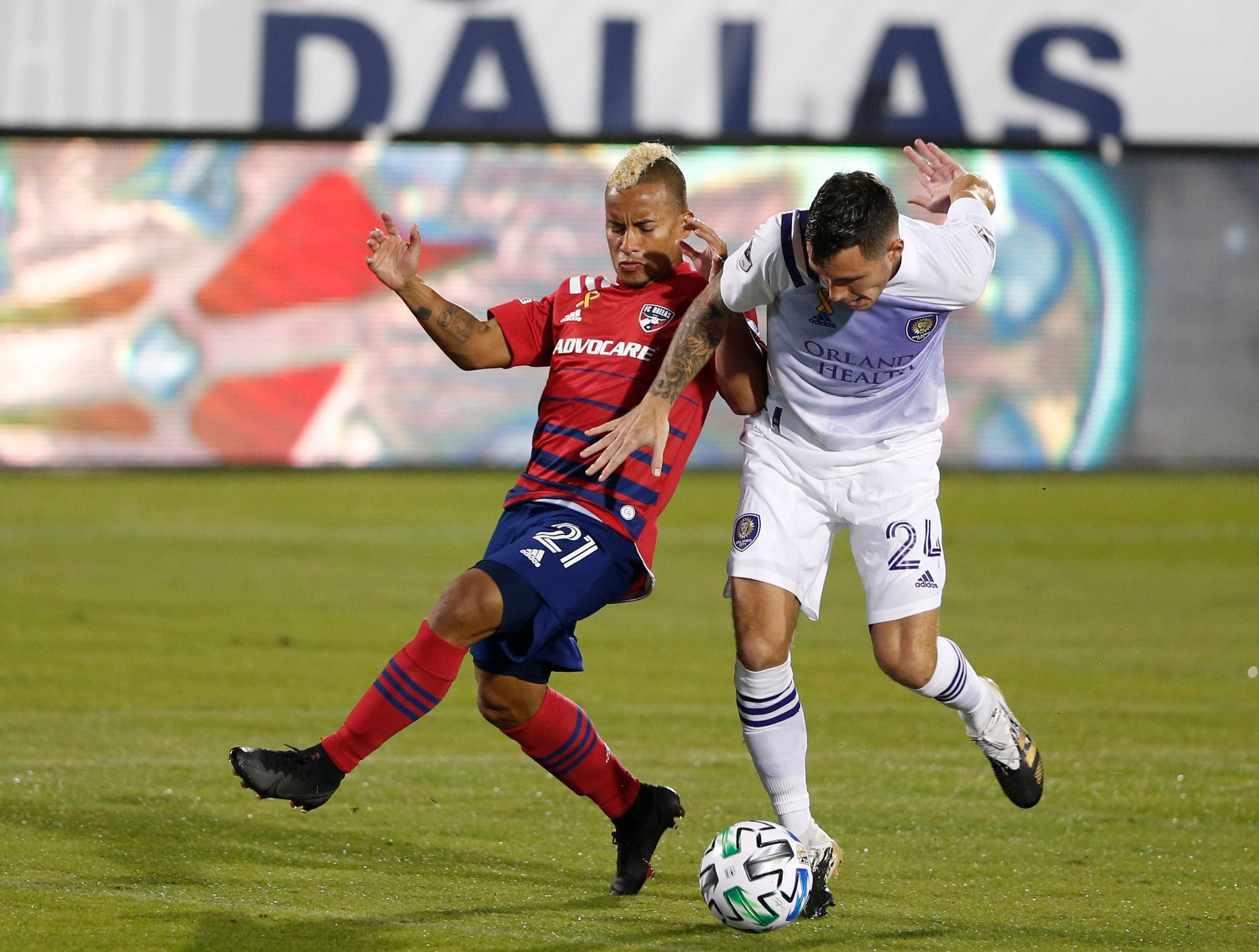 FC Dallas midfielder Michael Barrios (21) and Orlando City defender Kyle Smith (24) fight...