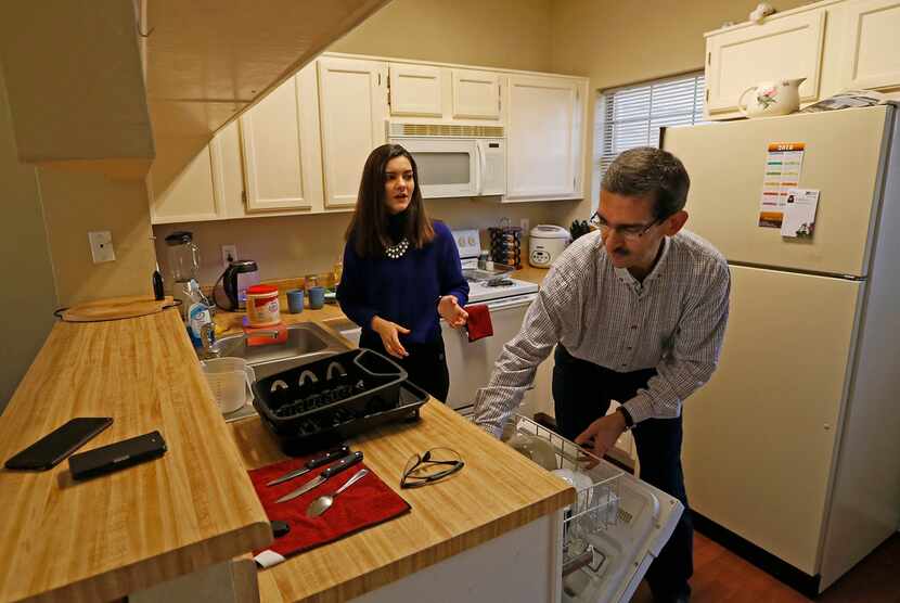 Sara Mohammed Saleem (left) talks with her father Faris Saleh in the kitchen at their home...