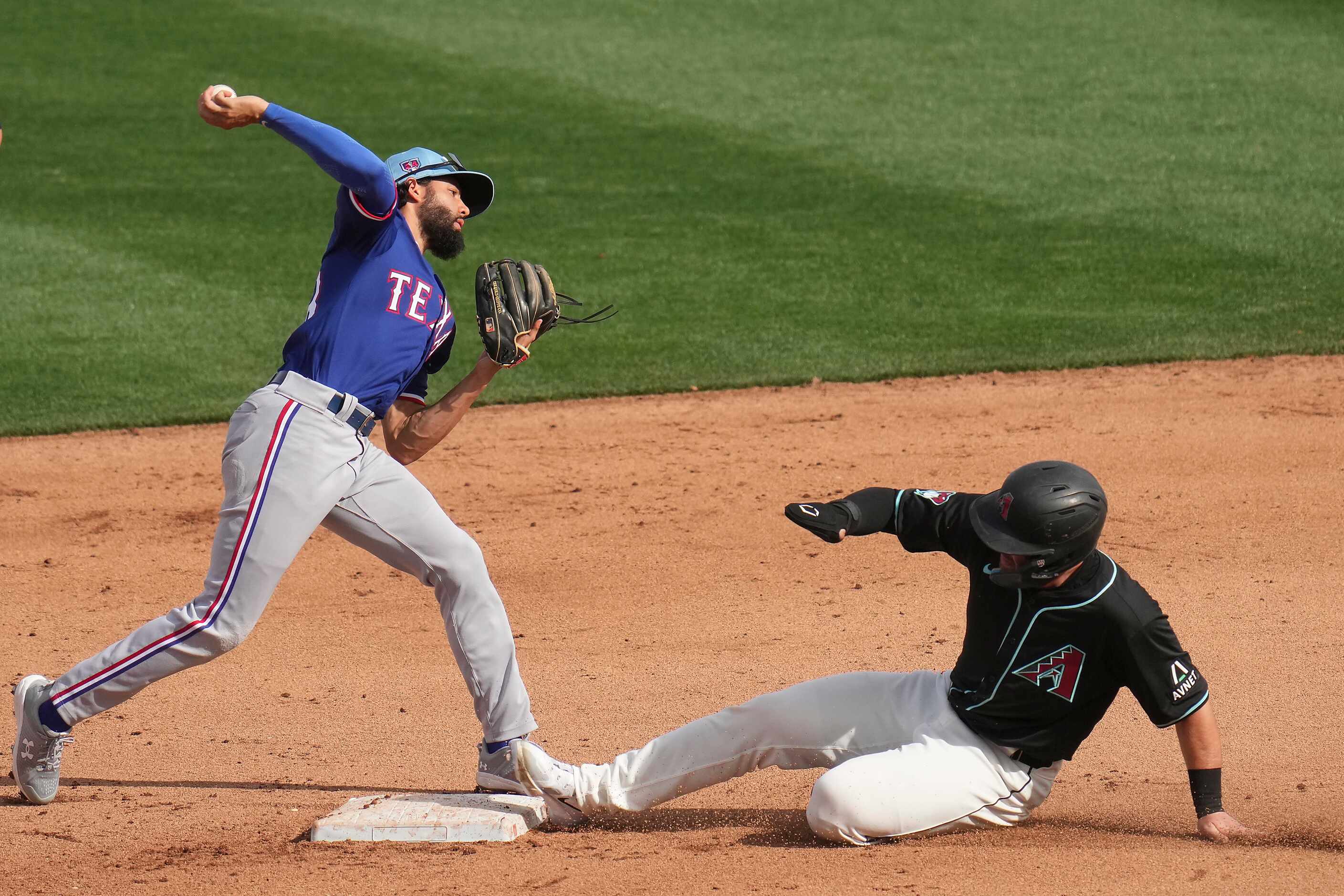 Texas Rangers second baseman Jayce Easley tries to turn a double play over Tim Tawa of the...