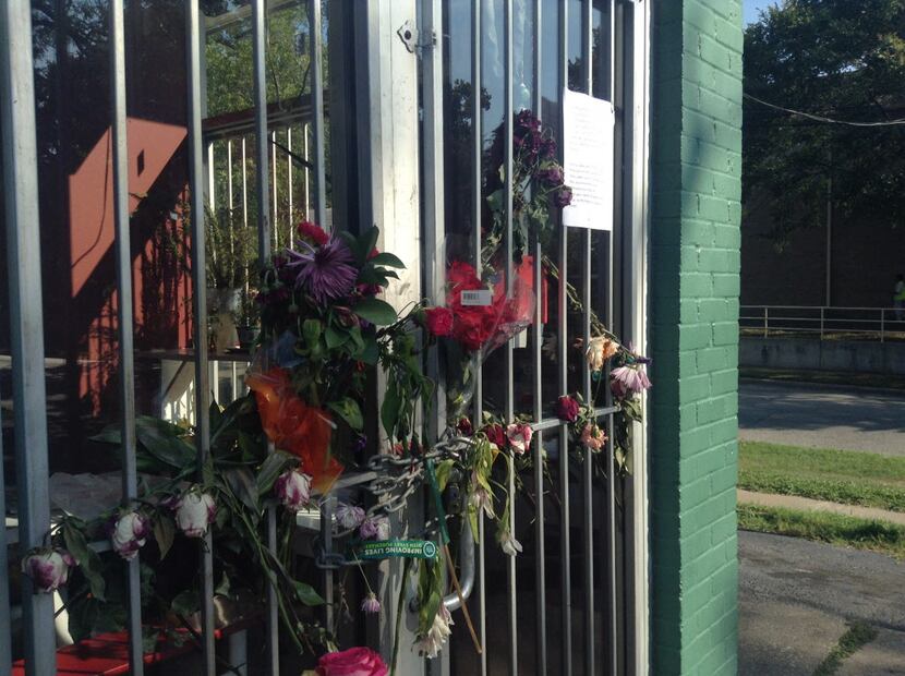 A bouquet of flowers is hanging on the Victoria Pupusería. The restaurant's owner, Victoria...