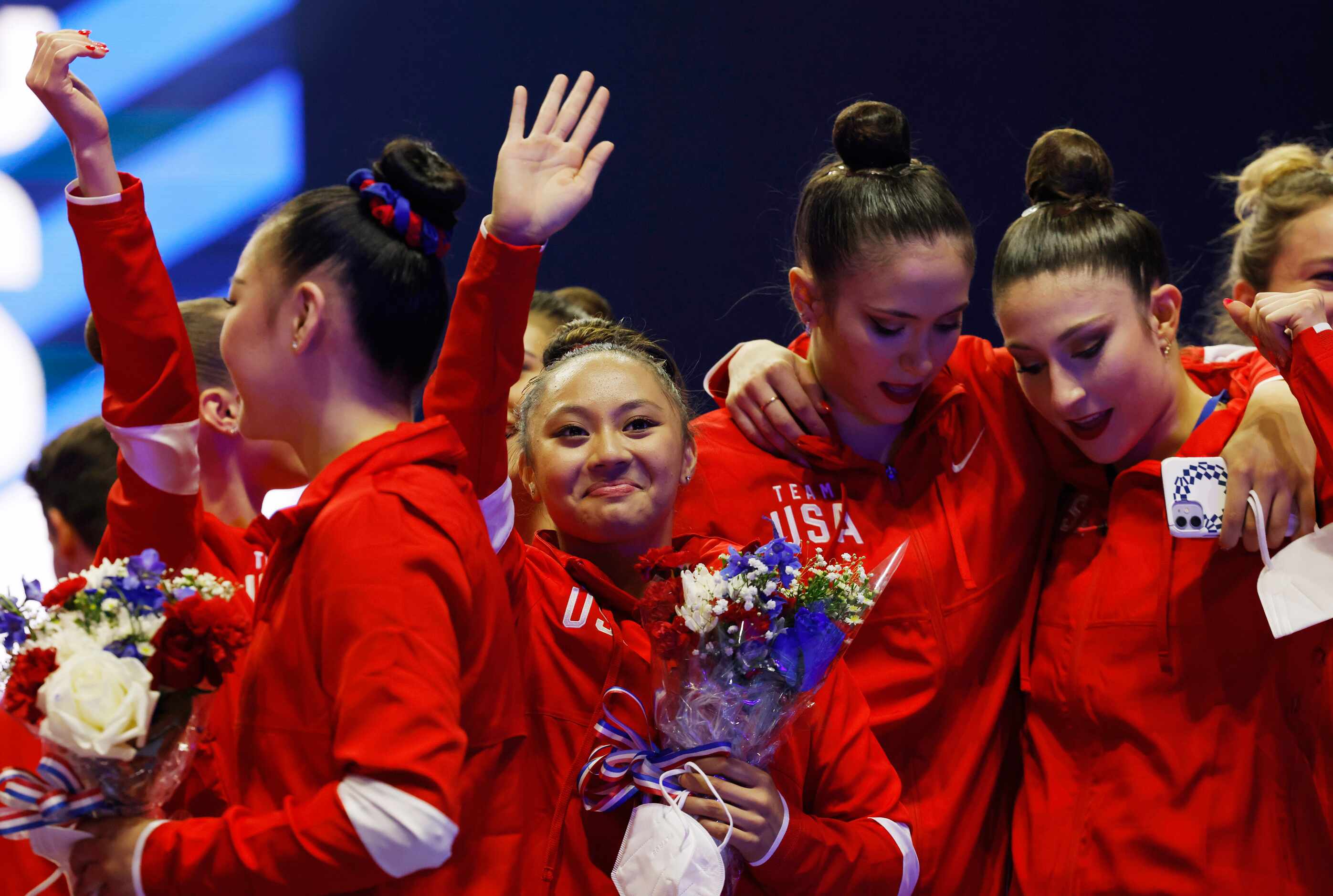 Emma Malabuyo waves to people in the crowd after the women's U.S. Olympic gymnastics team...