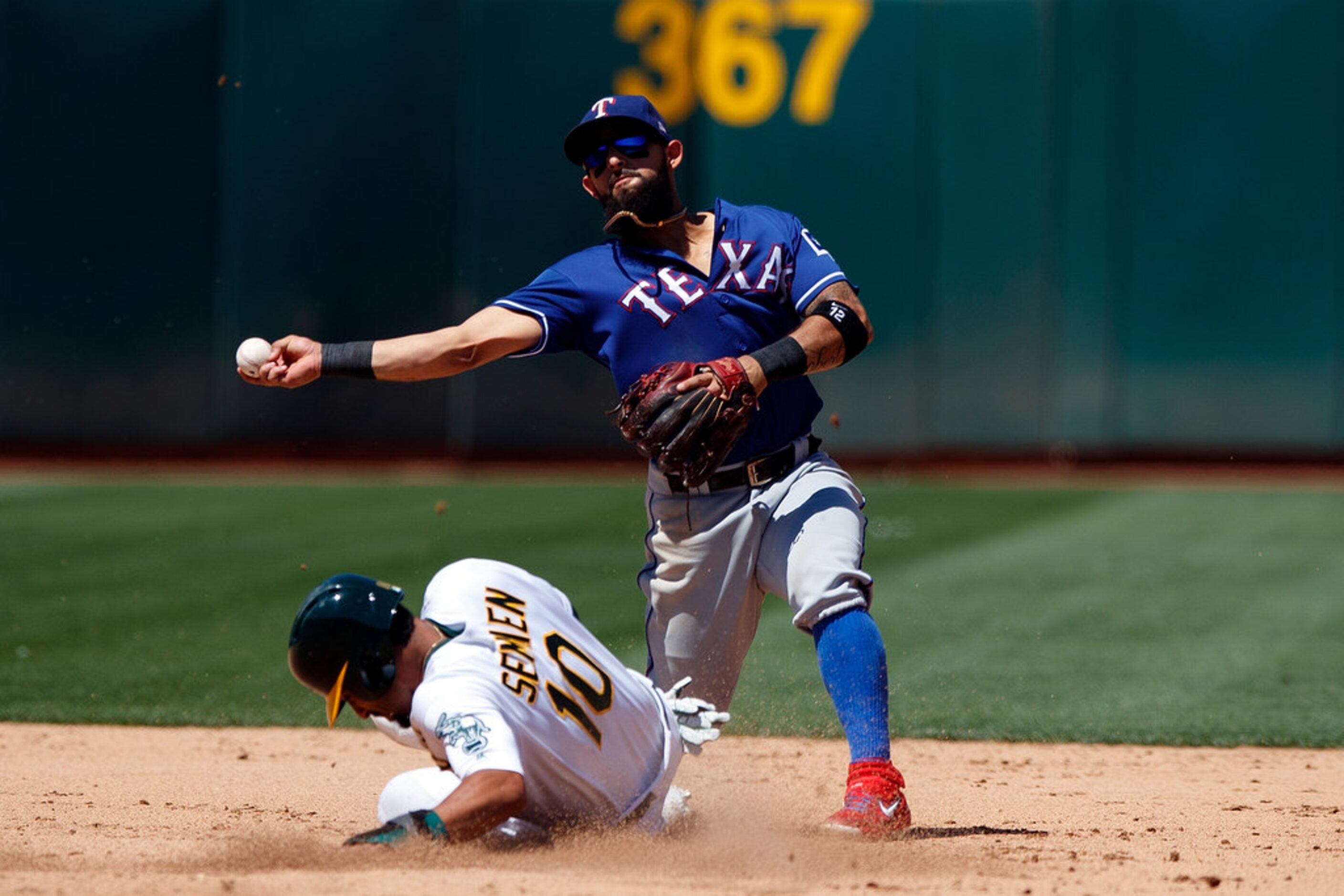 OAKLAND, CA - JULY 28:  Rougned Odor #12 of the Texas Rangers completes a double play over...