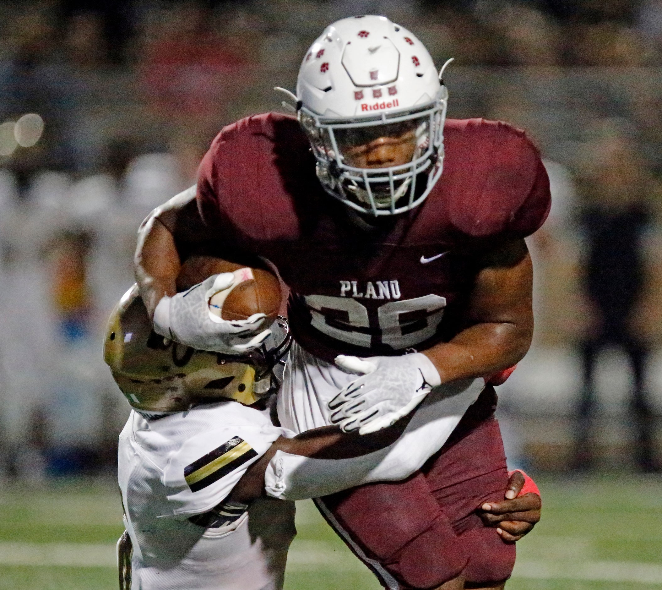 Plano Senior High School running back Kameron Jones (26) is tackled by Plano East High...