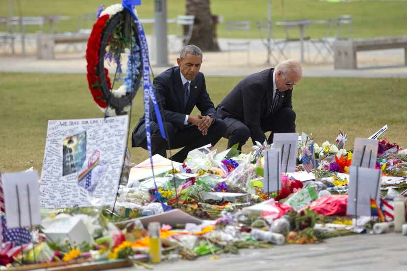 President Barack Obama and Vice President Joe Biden visit a memorial to the victims of the...