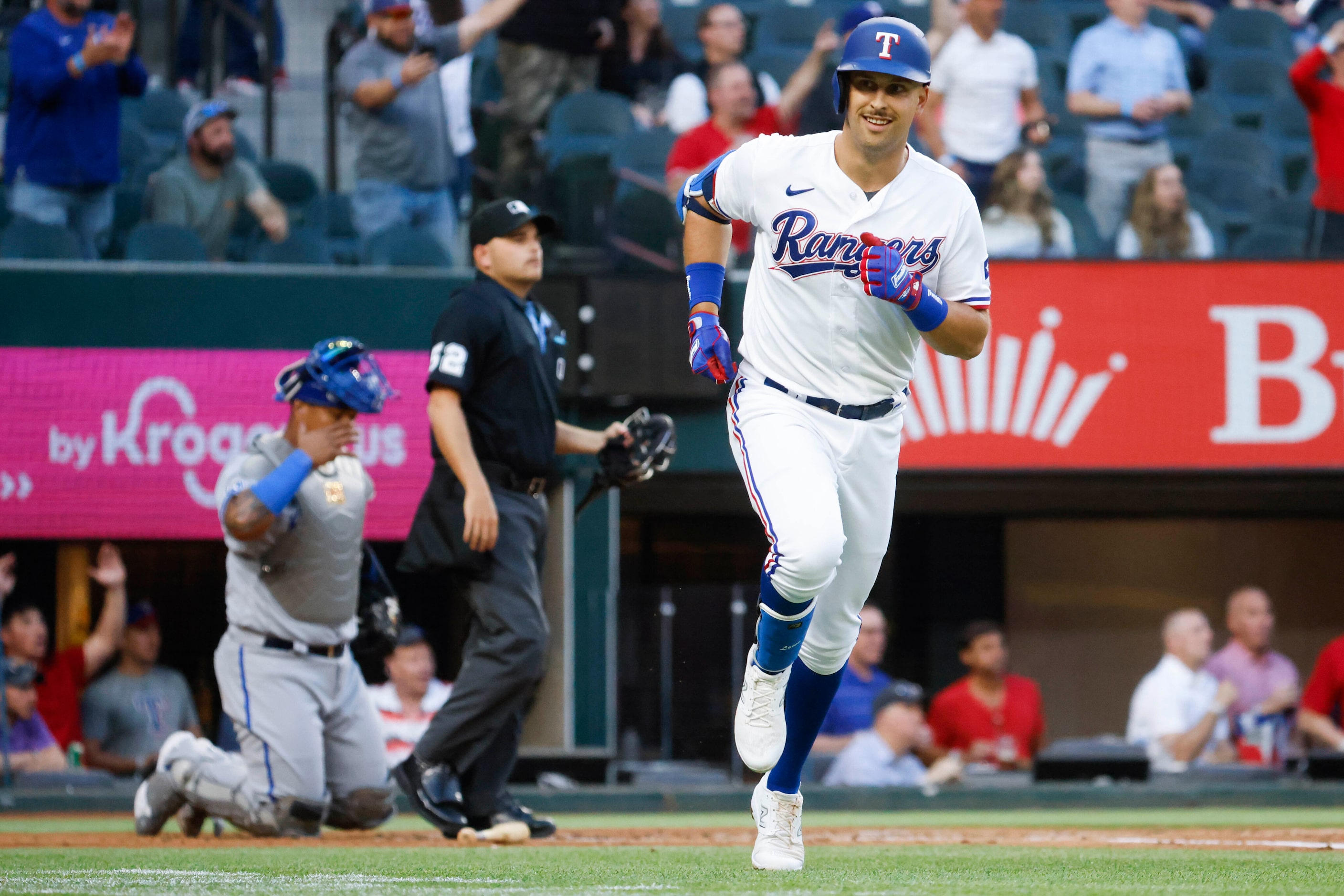 Texas Rangers first baseman Nathaniel Lowe reacts after hitting a home run on a fly ball...