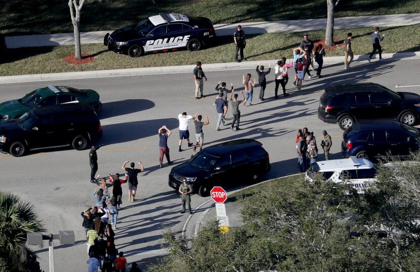 In this Wednesday, Feb. 14, 2018, file photo, students held their hands in the air as they...