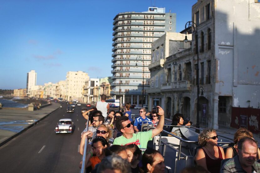 
Tourists ride a double-decker bus to take in the sights of Havana. 
