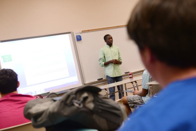 Greenhill School junior Christian Holmes gives an update on the stock market during an...