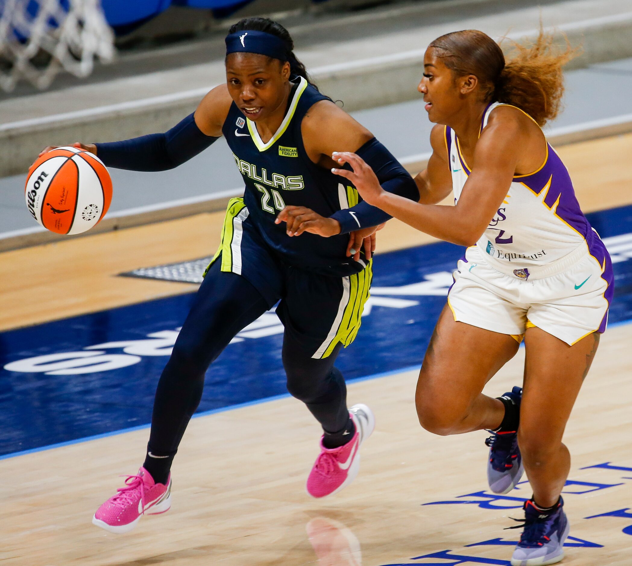 Los Angeles Sparks guard Te'a Cooper (2) guards Dallas Wings guard Arike Ogunbowale (24)...