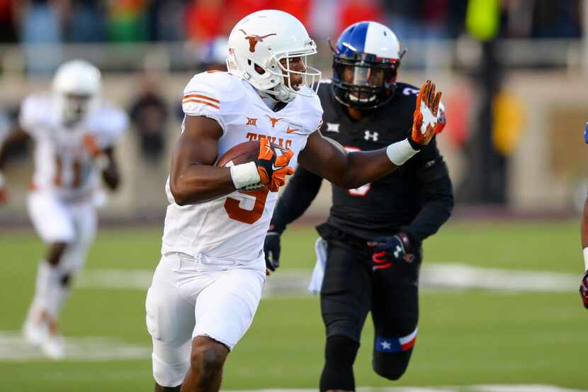 John Harris (9) of the Texas Longhorns carries the ball against the Texas Tech Red Raiders...