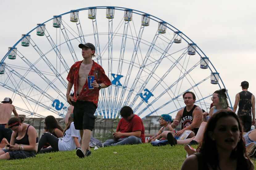 Fans relax on the lawn between concerts at the Warped Tour at Dos Equis Pavilion in Dallas...