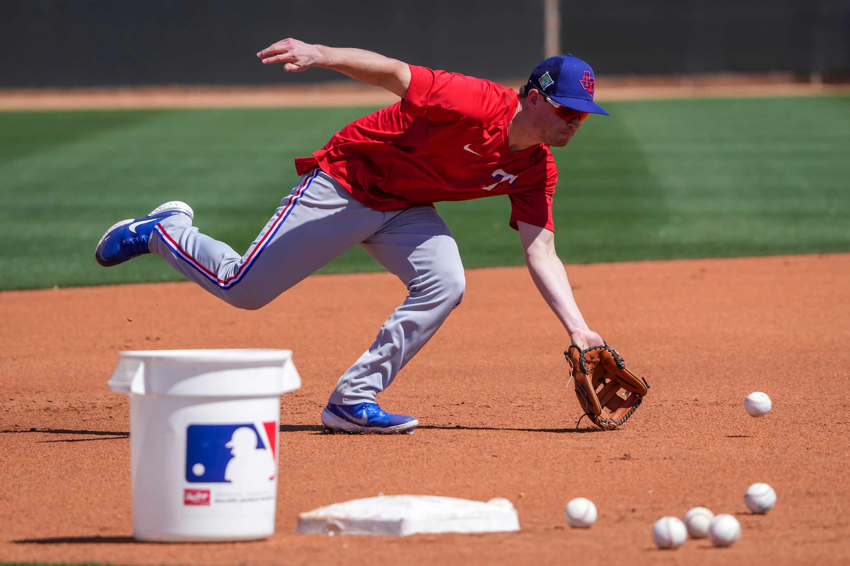 Texas Rangers infielder Nick Solak stays behind after the organized team workout to take...