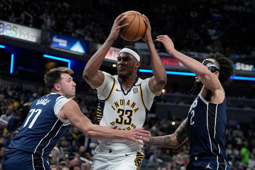 Indiana Pacers' Myles Turner (33) goes to the basket against Dallas Mavericks' Luka Doncic...