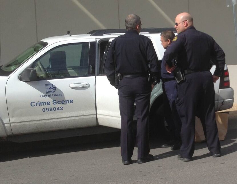 Dallas Police officers load items into a Crime Scene unit vehicle outside Baylor University...