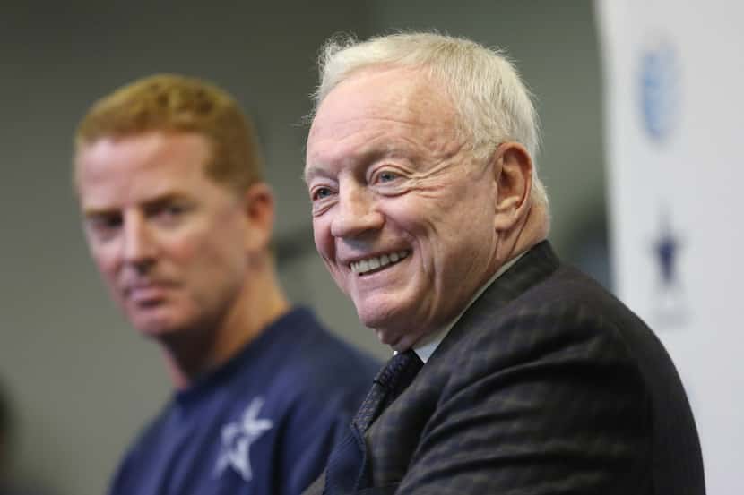 Dallas Cowboys owner Jerry Jones (right) shares a laugh with members of the media alongside...